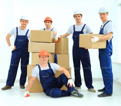 Removal team transporting furniture through a Southkensington street