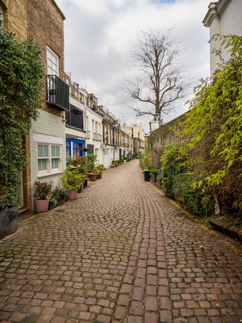 Image showing a row of elegant, multi-story residential buildings with classic architectural details such as decorative cornices and large sash windows, situated on a busy urban street in South Kensin